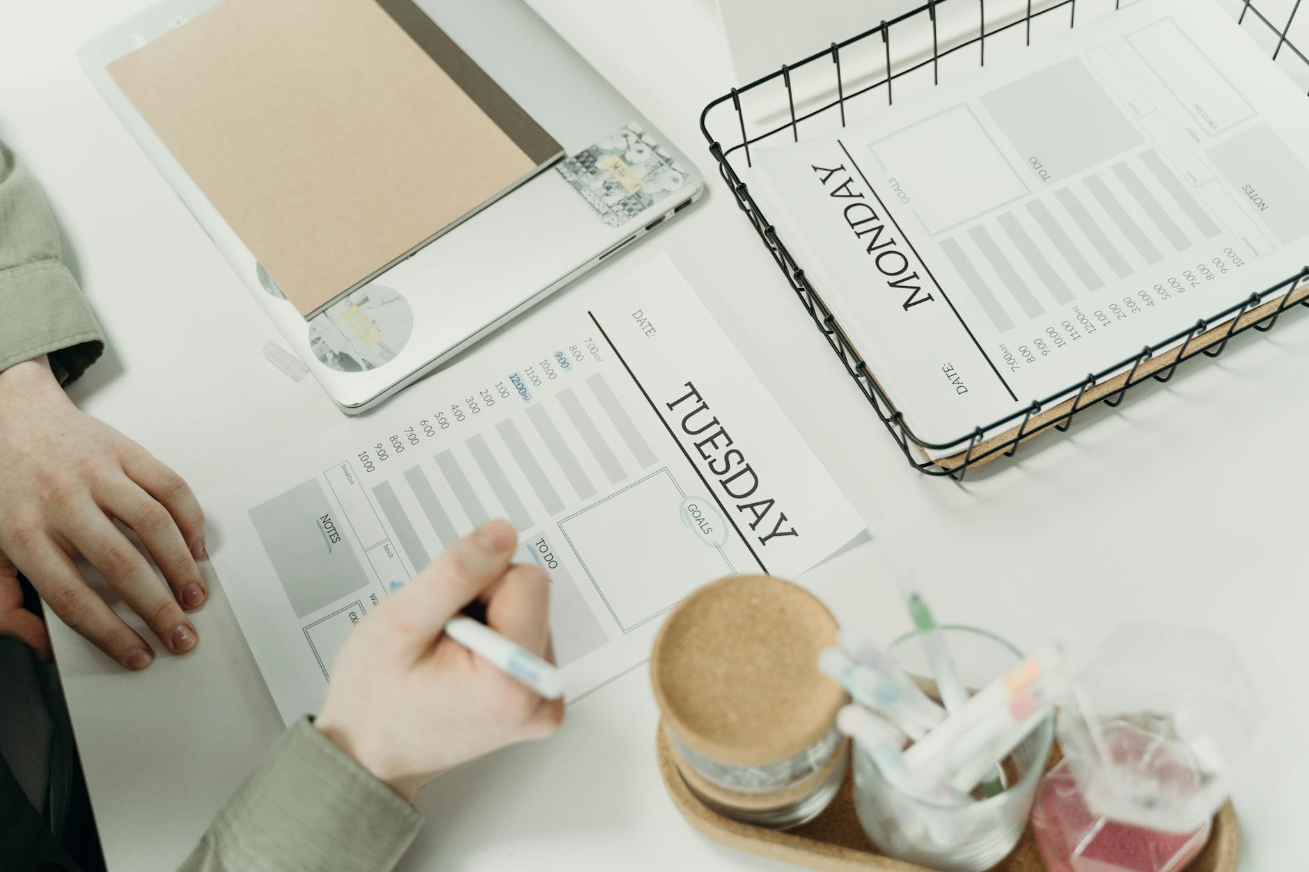A person carefully organizing a weekly planner with written schedules, illustrating the practical tools that help adults with ADHD structure their time