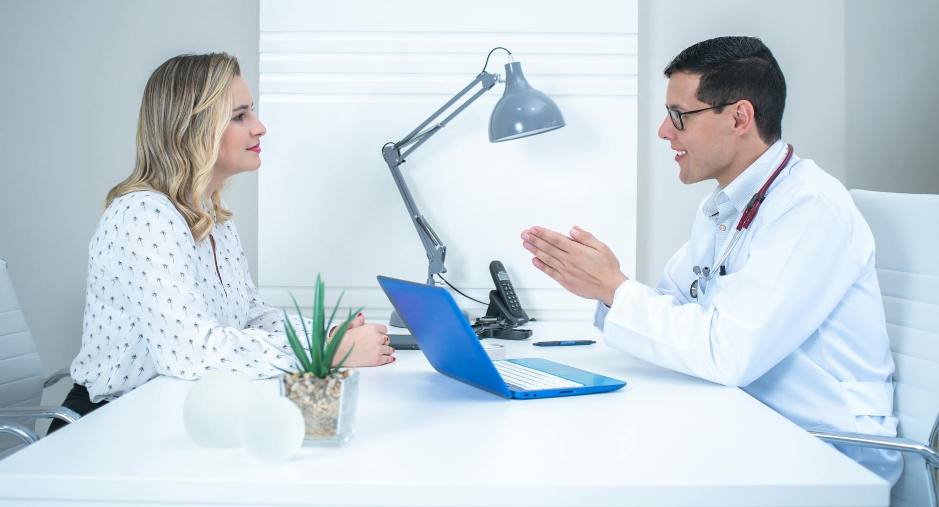 A doctor conducting a patient consultation in a bright, modern office — representing the open conversation needed when ADHD treatment needs adjustment